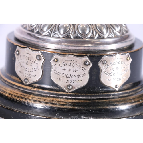 22 - Victorian sterling silver prize cup, on hardwood stand, the cup with chased border of figures, Elkin... 