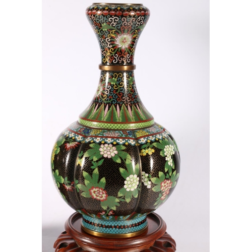 353 - A pair of early 20th century cloisonne vases with garlic top and lobed spherical body, the black gro... 