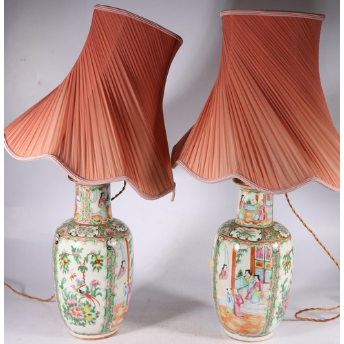 354 - Pair of late 19th century Canton famille rose vases of high shouldered form decorated with panels of... 