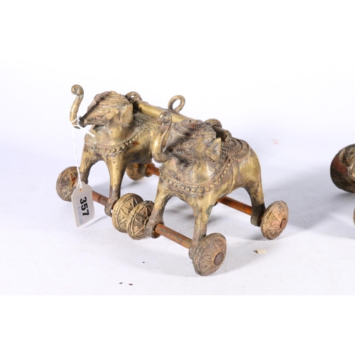 357 - Two early 20th century cast brass Indian wheeled toys, a pair of Indian elephants joined by a yoke w... 