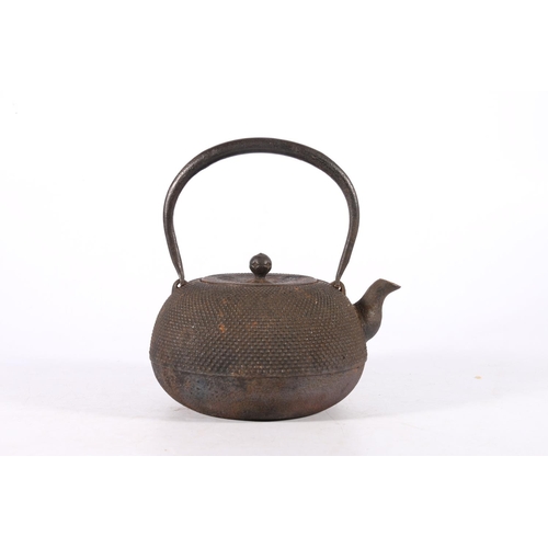 361 - An early 20th century iron tetsubin, with loop handles, the body half decorated with raised dots, th... 