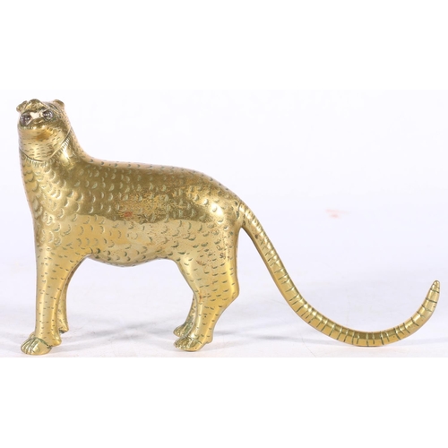 386 - 19th century Sri Lankan brass or bronze model of a leopard with long tail, holding an object in its ... 