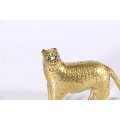 386 - 19th century Sri Lankan brass or bronze model of a leopard with long tail, holding an object in its ... 