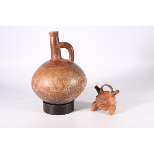 387 - Pre Columbian red glazed terracotta bottle of rounded shape with rounded handle, incised chevron det... 