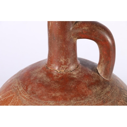 387 - Pre Columbian red glazed terracotta bottle of rounded shape with rounded handle, incised chevron det... 