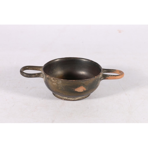 389 - Greek black glazed skyphos of shallow form with two loop handles, impressed palmate decoration to th... 