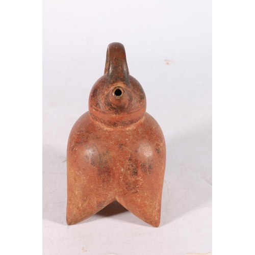 390 - Peruvian Chimu pottery double spouted stirrup jar, with spherical top and body on four pointed pap s... 