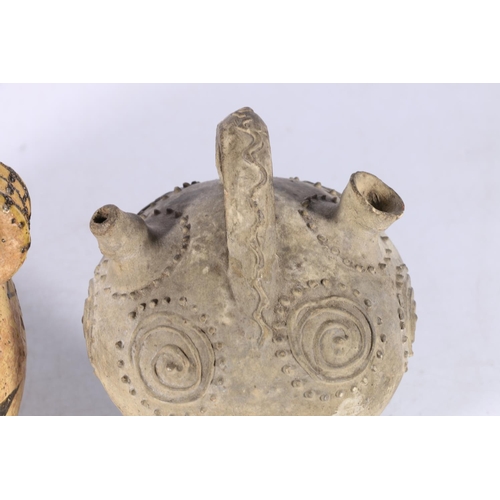 391 - A pre Columbian vessel with single loop handle, the spherical body decorated with geometric designs,... 