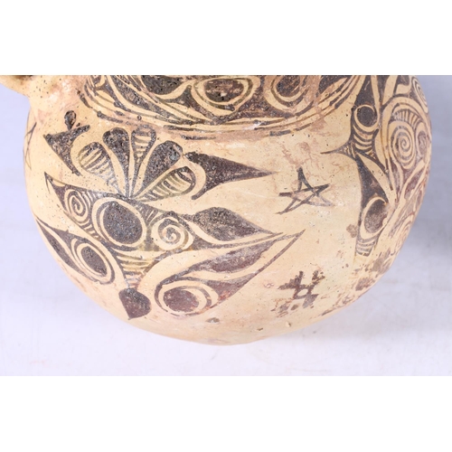 391 - A pre Columbian vessel with single loop handle, the spherical body decorated with geometric designs,... 