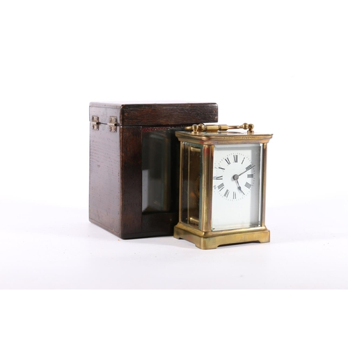 403 - Brass four glass carriage clock, with carry handle and white dial with Roman numerals, the back plat... 