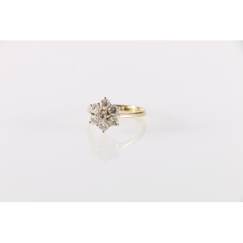 77 - 18ct gold diamond seven stone dress ring, the central diamond approximately 0.15ct encircled by six ... 