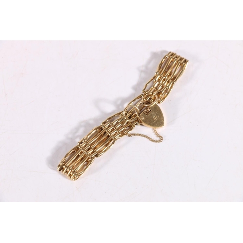 96 - 9ct yellow gold five bar gate link bracelet with heart closure, stamped LC, 13.4g.