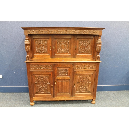 576 - Antique carved oak court cupboard of typical form with Jacobean style profuse carvings depicting thi... 