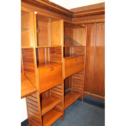 585 - Ladderax teak modular shelving unit, with plaques 'Staples and Co Ladderax', 370cm long.