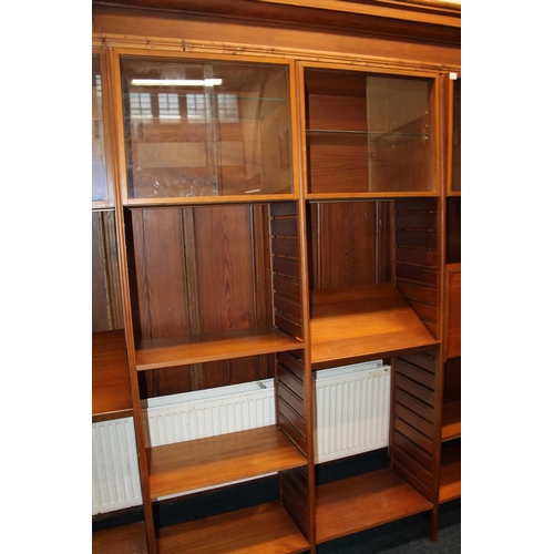 585 - Ladderax teak modular shelving unit, with plaques 'Staples and Co Ladderax', 370cm long.