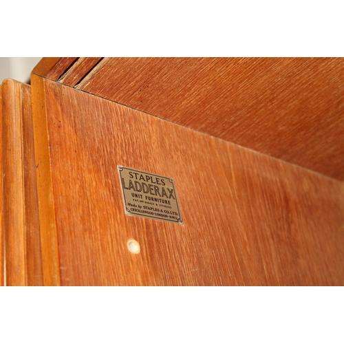 585 - Ladderax teak modular shelving unit, with plaques 'Staples and Co Ladderax', 370cm long.