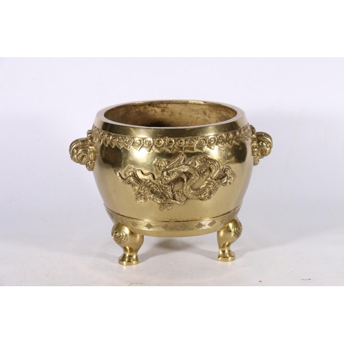 362 - A gilt brass jardiniere on triple supports, the body decorated beneath a ruyi head band with dragons... 