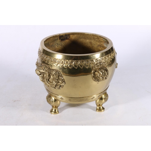 362 - A gilt brass jardiniere on triple supports, the body decorated beneath a ruyi head band with dragons... 