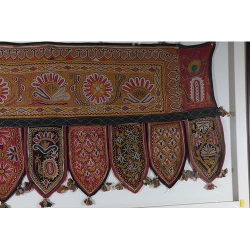 363 - An Indian hanging panel with floral embroidery, the main panel decorated with flowerheads with nine ... 