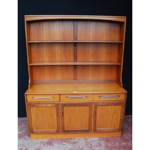 378 - Mid-20th century G Plan teak dresser, the detachable top with open shelving above three short drawer... 