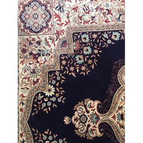 600 - Large wool rug, midnight blue field with floral decoration, carpet size 400cm x 300cm.