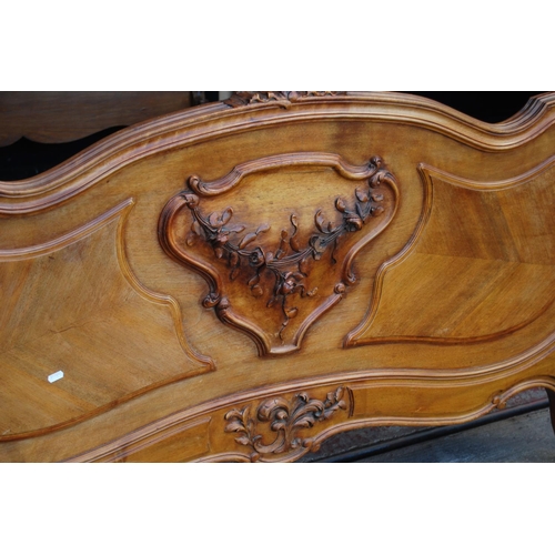 369 - French walnut king size bed, the main bed end with a carved scroll and torch surmount, both ends wit... 