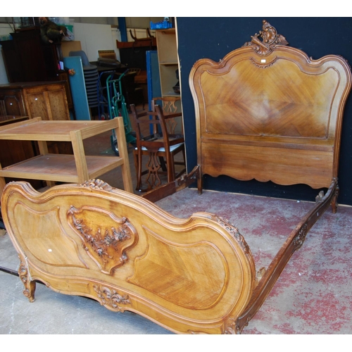 369 - French walnut king size bed, the main bed end with a carved scroll and torch surmount, both ends wit... 