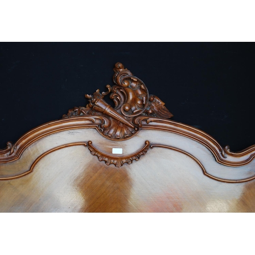 369 - French walnut king size bed, the main bed end with a carved scroll and torch surmount, both ends wit... 