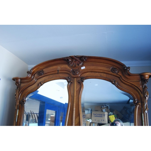 370 - French walnut armoire, with a detachable surmount above a shaped cornice decorated with floral round... 