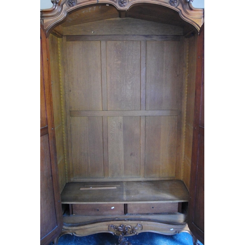 370 - French walnut armoire, with a detachable surmount above a shaped cornice decorated with floral round... 