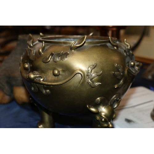 355 - Large Chinese brass censer on triple ball and claw supports with lion mask surmounts, the body decor... 