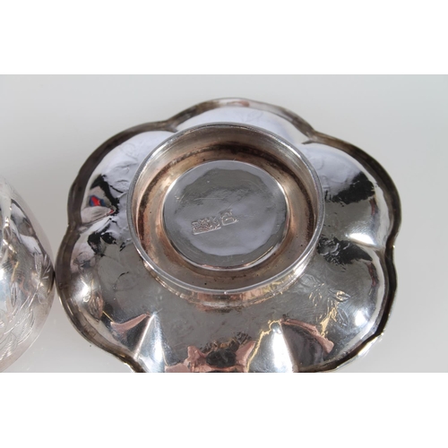 473 - Chinese lobed silver dish and matching cup with all over floral decoration, marks to the base, 75g.