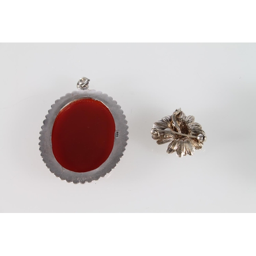 520 - Silver pendant set with large red stone and a Danish silver floral brooch.