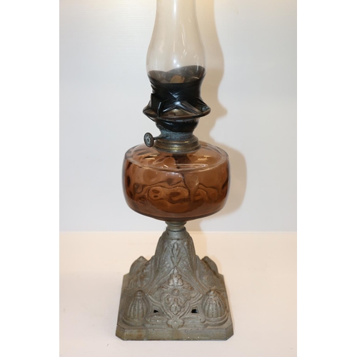 39 - Early 20th century paraffin lamp raised on metal base.