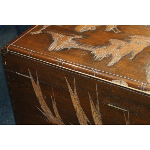 719 - Chinese carved camphorwood blanket box, 94cm wide.