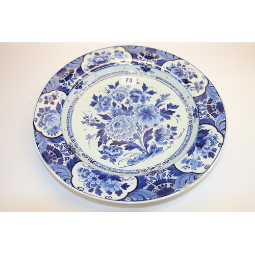 73 - Delft floral decorated charger, 34cm diameter.