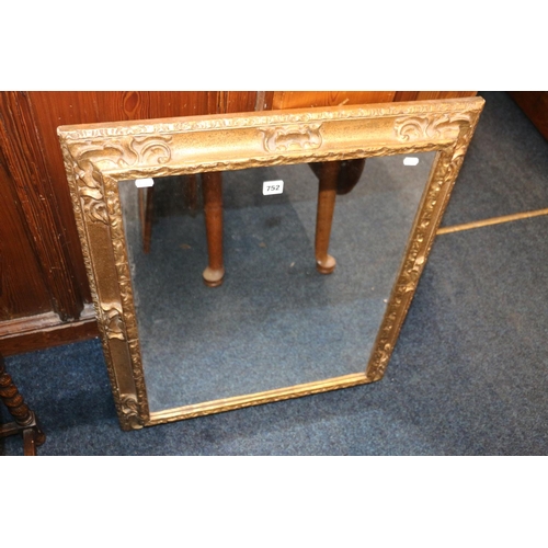 752 - Ornate gilt framed wall mirror, 80cm x 67cm.