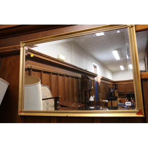 753 - Gilt framed bevelled edge wall mirror, 63cm x 93cm. 