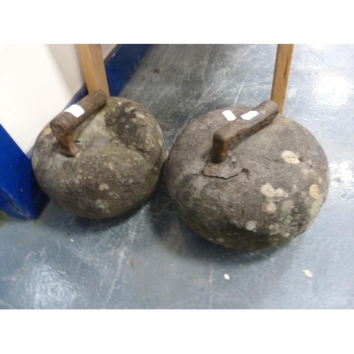 45 - Two curling stones with iron handles.