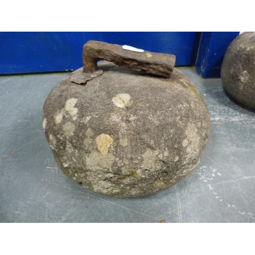 45 - Two curling stones with iron handles.