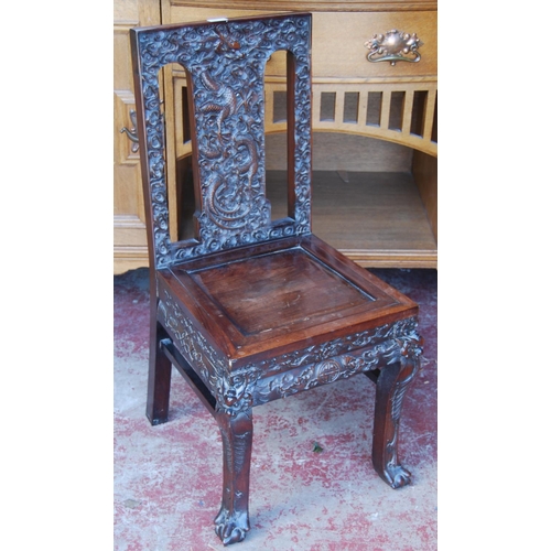 381 - Chinese Qing carved hongmu chair carved profusely with dragons, flaming pearl and scrolls to the bac... 