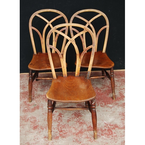 387 - Three late 19th century near-matching Gothic Windsor ash and elm chairs, each with lattice back abov... 