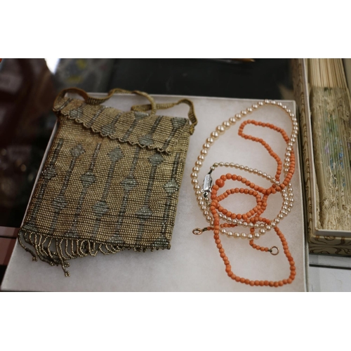 419 - Ladies evening purse, yellow metal necklace, coral necklace and a fan.