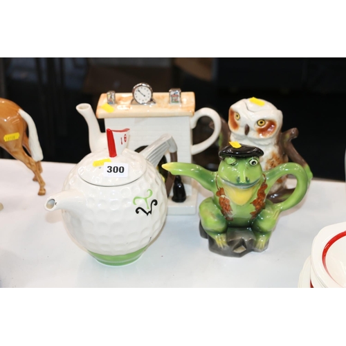 300 - Four novelty teapots, golfing, owl, frog, etc.