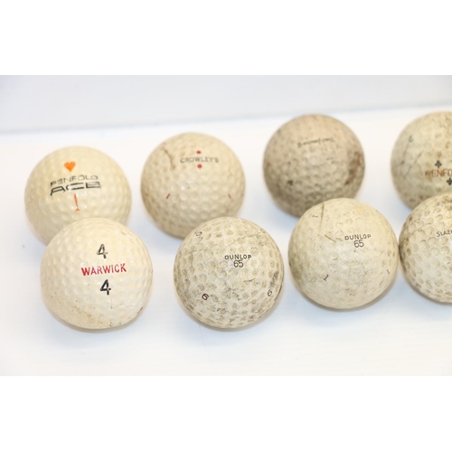 94 - Vintage golf balls, a golfer finial and a pack of vintage Famous Grouse tees.