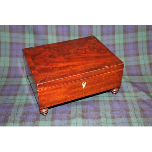 132 - Mahogany hinge top sectional box on turned feet, 23cm.