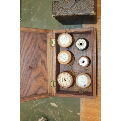 261 - Carved wood box and a box containing haberdashery to include spools, clock key, etc.