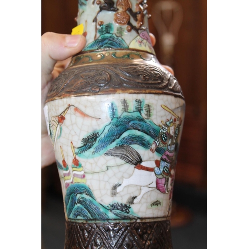 150E - Oriental twin-handled crackleware vase decorated with warriors, mark to base, 25cm.