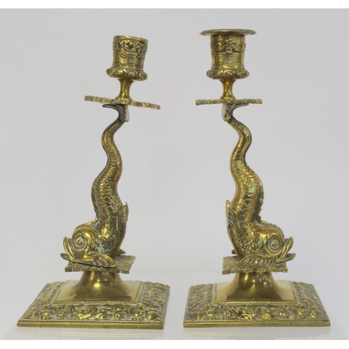 238 - Pair of brass candlesticks with foliate moulded sconces and drip trays on dolphin moulded columns an... 