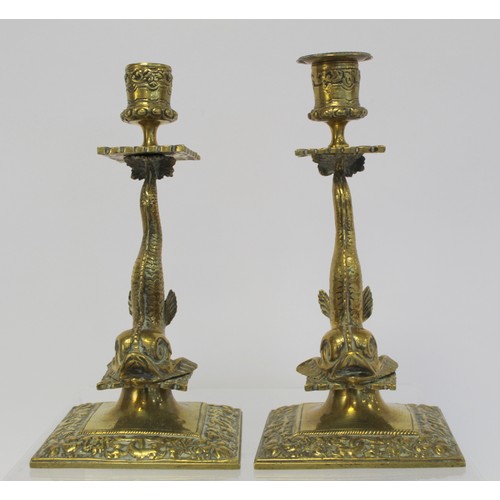 238 - Pair of brass candlesticks with foliate moulded sconces and drip trays on dolphin moulded columns an... 